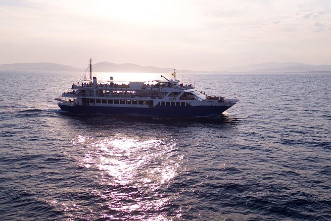 Athens: Island Swimming Day Cruise—DJ, Lunch & Drinks incl. - Stop 1, Agistri: turquoise swim time and rocky-water reality