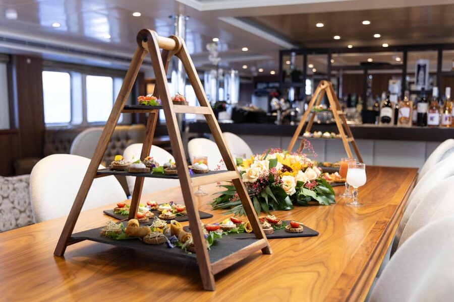 Athens: Saronic Islands Cruise with VIP Area Seating & Lunch - Poros: pine trees, beach edges, and an hour that is more break than tour