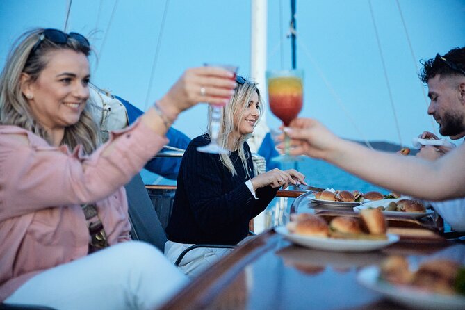 Athens Sunset Dinner Cruise – Swim Stop, Dinner & Open Bar - Sailing Past Glyfada, Ellinikon, Alimos Marina, and Castella